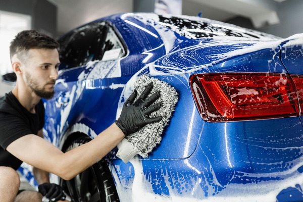 car-washer-doing-manual-foam-washing-auto-detailing-service-hand-washing-with-microfiber-glove-with-foam-car-body-garage1.jpg